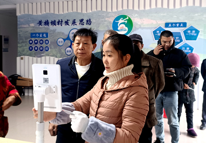 志愿者在上馬鎮(zhèn)黃桷壩村黨群服務(wù)中心幫助群眾“掃臉”激活醫(yī)保電子憑證。納溪區(qū)醫(yī)保局供圖